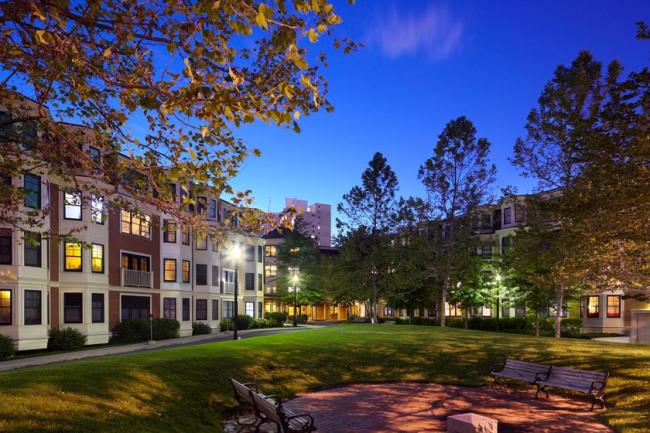 The exterior of the Pleasant Street Condominiums in Cambridge, Massachusetts at night.
