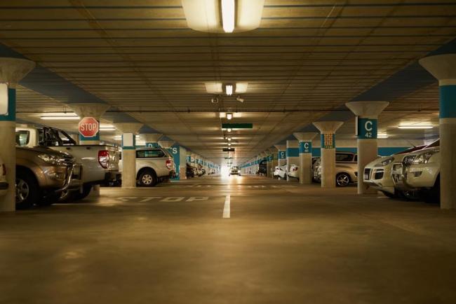 Underground parking garage full of parked cars