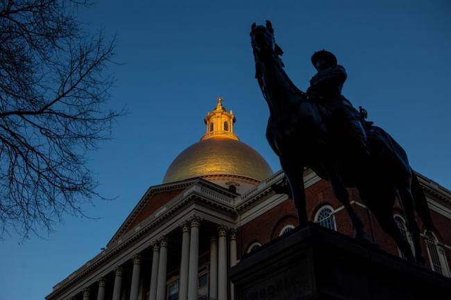 Low angle at night of the Massachusetts State Capitol building in Boston.