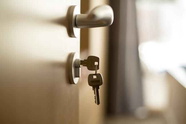 an image of a door handle with keys dangling from the lock