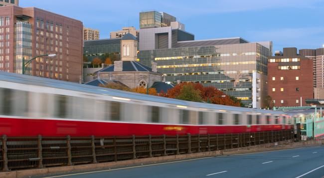 a subway train quickly passing by in an urban environment