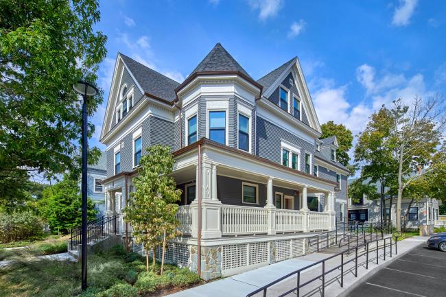 5 Sacramento: A newly renovated light blue building with classic features, with blue skies, green grass, and lush trees.