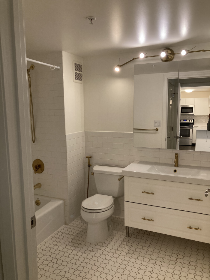Bathroom with white tile and white cabinetry