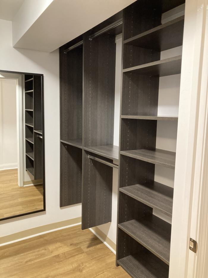 A walk in closet with built ins