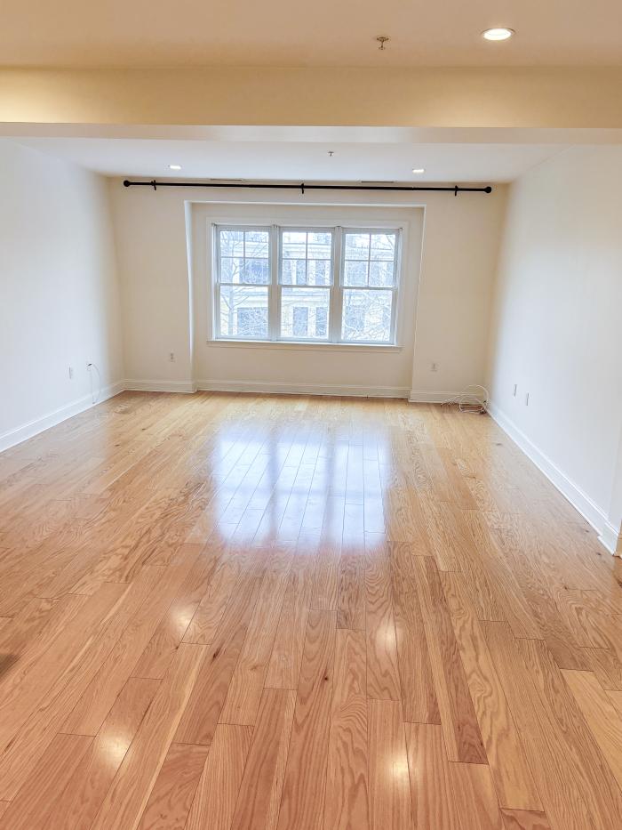 The living room of 173 401 - bright windows and hardwood flooring