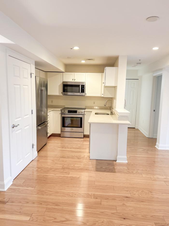 The kitchen of 173 401 with white cabinetry and stainless steel appliances