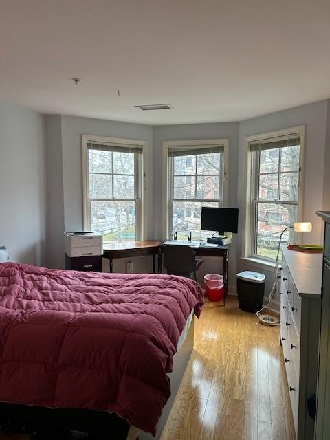 bedroom with hard floors and bay windows