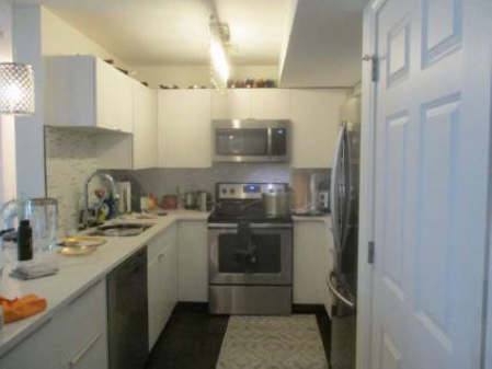 kitchen with white countertops and cabinetry, stainless steel appliances