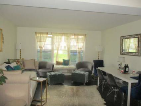 combined living and dining room with large windows