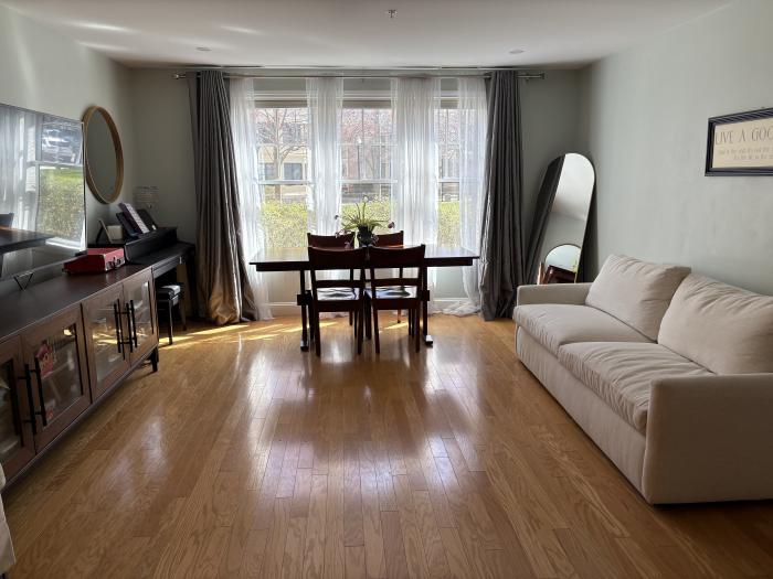 living room with large windows and hardwood flooring