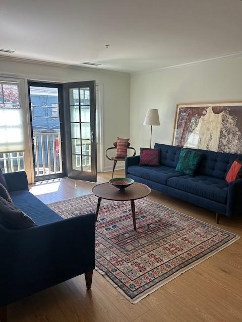 living and dining area with large windows and hard flooring.