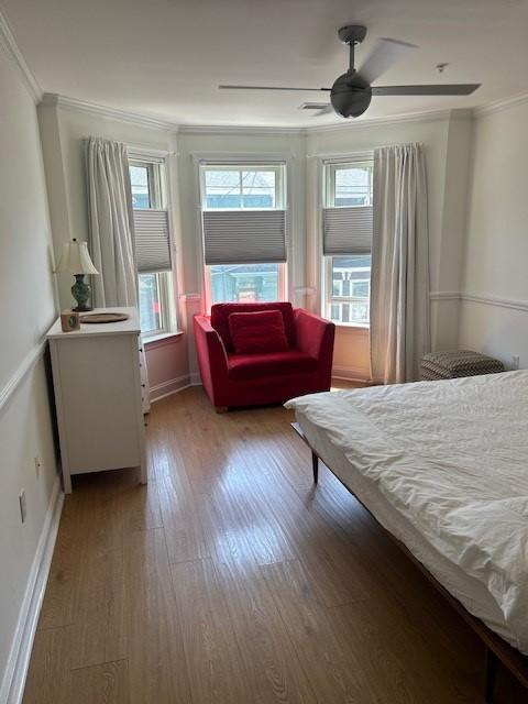 Primary bedroom with bay windows and hard flooring