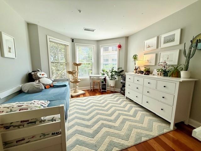 Second bedroom with hard flooring and bay windows
