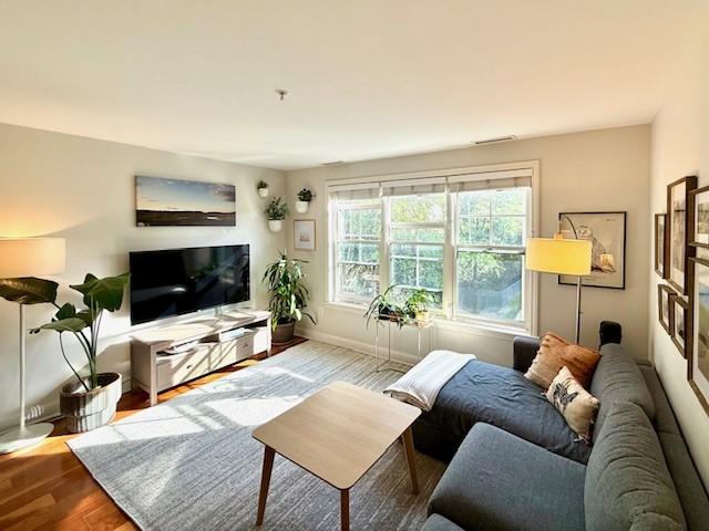 living room with hard floors and large windows