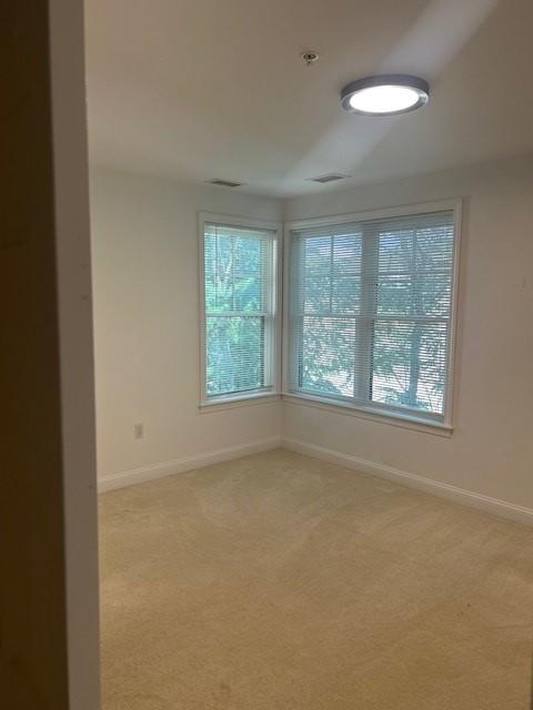 second bedroom with carpeting and large corner window