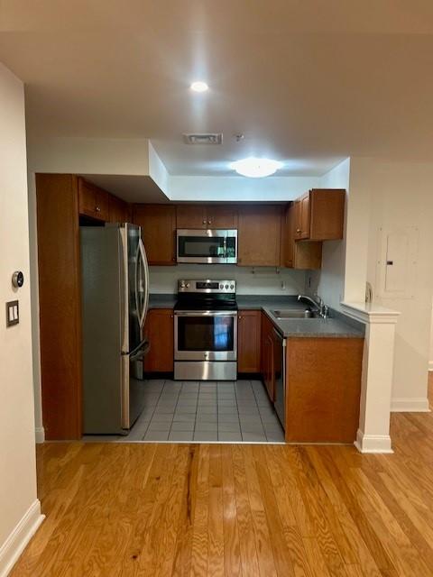 Kitchen with stainless steel appliances and wood cabinetry