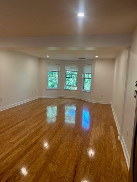 Living/dining area, open concept. Hard flooring and recessed lighting. Bay windows.