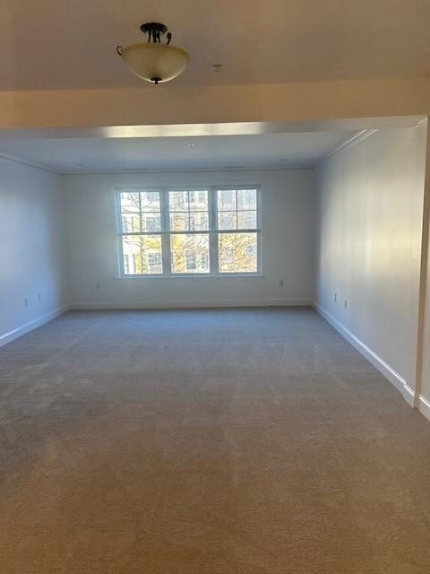 Combined living and dining with carpet flooring. overhead lighting, and large window panels