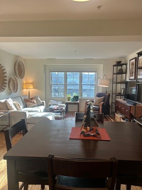 Combined living and dining area with large windows