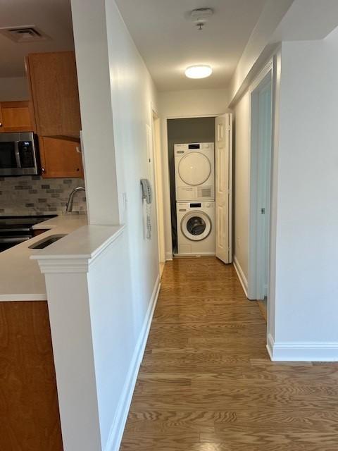 laundry closet with stacked washer and dryer