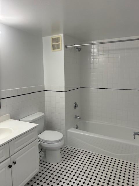 Secondary bathroom with toilet, tub/shower combo, sink/vanity, and tile flooring