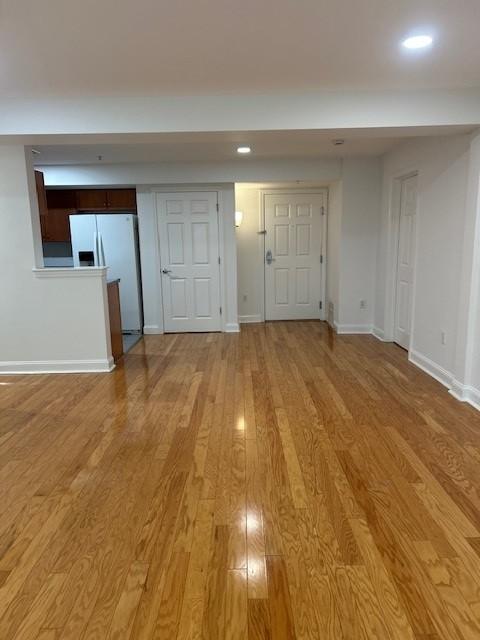 Combined living/dining area with hard flooring and overhead lighting