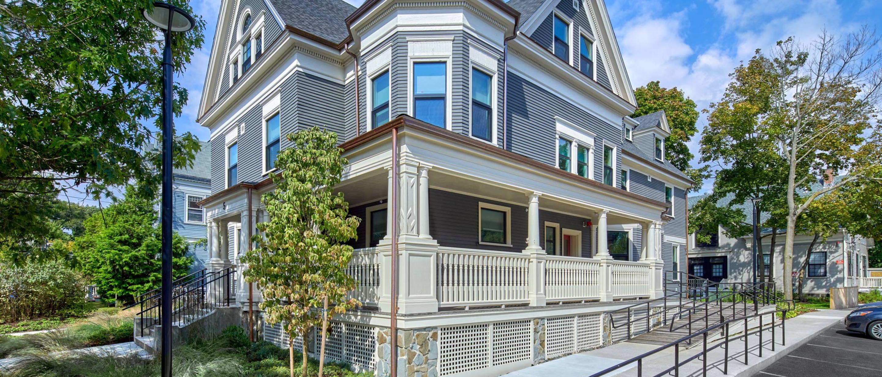 5 Sacramento: A newly renovated light blue building with classic features, with blue skies, green grass, and lush trees.