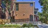 The rear view of 13 Kirkland, with an accessibility ramp leading to the rear entry and porch area