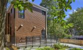 The rear view of 13 Kirkland, with an accessibility ramp leading to the rear entry and porch area