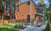 The back of 13 Kirkland: a newly renovated building with a bright red door and lush greenery