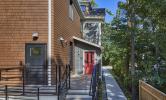 The rear view of 13 Kirkland, with an accessibility ramp leading to the rear entry and porch area