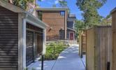 The rear view of 13 Kirkland, with the sidewalk leading from the back entry to the bike shed and compost area