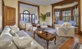 A furnished living room space with cozy couches, a coffee table, and rug.