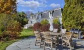 The patio feature at Howells House with chairs for gathering on a stone-inlayed patio