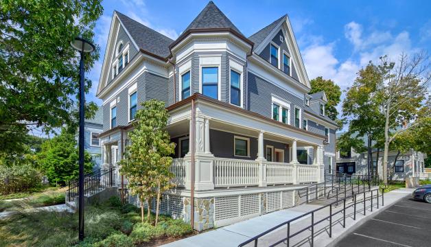 5 Sacramento: A newly renovated light blue building with classic features, with blue skies, green grass, and lush trees.